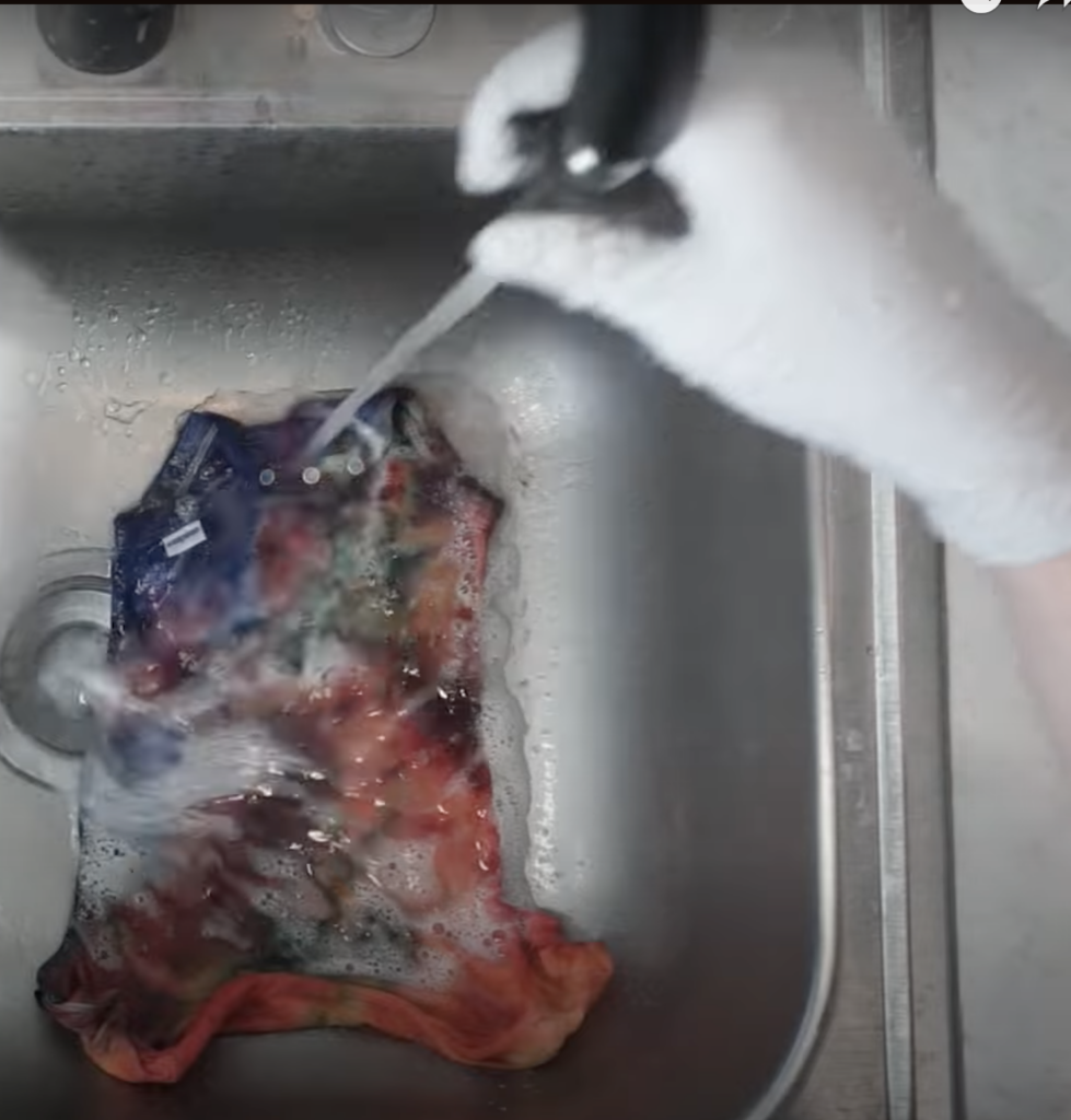 A sink shot mid-rinse or soap suds on dyed fabric